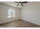 A bedroom with wood floor and arched window at 5028 W Shangri La Rd, Glendale, AZ 85304