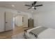 Bright bedroom with wood floors, ceiling fan, and convenient access to the bathroom at 5028 W Shangri La Rd, Glendale, AZ 85304