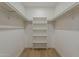 Walk-in closet with wood floor and white shelving perfect for storage at 5028 W Shangri La Rd, Glendale, AZ 85304