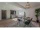 Dining room featuring modern decor, stylish lighting, and light colored hardwood floors at 5028 W Shangri La Rd, Glendale, AZ 85304