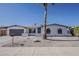 Single story home with white brick, desert landscaping, and an attached two car garage at 5028 W Shangri La Rd, Glendale, AZ 85304