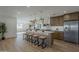 Open concept kitchen with light wood cabinets, stone countertops, and modern pendant lighting at 5028 W Shangri La Rd, Glendale, AZ 85304