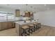 Open concept kitchen with light wood cabinets, stone countertops, and an island with seating at 5028 W Shangri La Rd, Glendale, AZ 85304