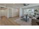 Living room with a large window, gray sofa, wood floors, and neutral paint at 5028 W Shangri La Rd, Glendale, AZ 85304