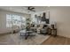 Living room with a large window, gray sofa, wood floors, and modern decor at 5028 W Shangri La Rd, Glendale, AZ 85304