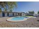 Backyard pool featuring a unique design and light gray concrete perimeter, complemented by a desert landscape at 5028 W Shangri La Rd, Glendale, AZ 85304