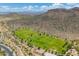 Aerial view of a lush green sports field and desert landscape set against mountain views at 5123 W Redbird Rd, Phoenix, AZ 85083