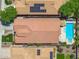 An aerial view showcasing a home with solar panels and a private pool at 5123 W Redbird Rd, Phoenix, AZ 85083