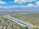 Panoramic aerial view showcasing a canal running through a community with desert mountains in the background at 5123 W Redbird Rd, Phoenix, AZ 85083