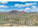 Scenic aerial view of a desert community, showcasing tree-lined streets and mountain views at 5123 W Redbird Rd, Phoenix, AZ 85083