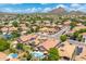 A beautiful aerial view captures a neighborhood featuring private pools, desert landscaping and solar panels at 5123 W Redbird Rd, Phoenix, AZ 85083