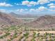 An elevated perspective of a community nestled between arid hills and mountains at 5123 W Redbird Rd, Phoenix, AZ 85083