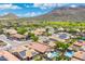 Picturesque aerial shot of homes with solar panels, lush landscaping, private pools, and gorgeous mountain views at 5123 W Redbird Rd, Phoenix, AZ 85083