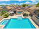 A stunning backyard oasis with a pool, spa, and patio seating under blue skies at 5123 W Redbird Rd, Phoenix, AZ 85083