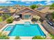 A stunning backyard oasis with a pool, spa, and patio seating area at 5123 W Redbird Rd, Phoenix, AZ 85083