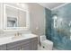 Modern bathroom with custom sink, and a glass-enclosed shower with luxurious blue tile at 5123 W Redbird Rd, Phoenix, AZ 85083