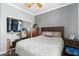 Cozy bedroom featuring a bed, mirrored closet, and wood-look floors. Closet is full of clothing at 5123 W Redbird Rd, Phoenix, AZ 85083