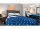 Comfortable bedroom features a bed, side tables, and a sliding mirror closet with built-in shelving at 5123 W Redbird Rd, Phoenix, AZ 85083