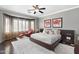 Spacious primary bedroom features a decorative rug, sitting chair, and a large window with privacy at 5123 W Redbird Rd, Phoenix, AZ 85083