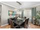 Modern dining room featuring a stylish light fixture, a dark wood table with seating for six, and neutral décor at 5123 W Redbird Rd, Phoenix, AZ 85083