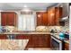 Updated kitchen with mosaic backsplash, cherry cabinets and stainless appliances at 5123 W Redbird Rd, Phoenix, AZ 85083