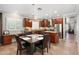 Updated eat-in kitchen features cherry wood cabinets, stainless appliances, granite counters, and breakfast bar at 5123 W Redbird Rd, Phoenix, AZ 85083