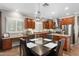 Elegant eat-in kitchen with cherry wood cabinets, granite counters, stainless appliances, and center island at 5123 W Redbird Rd, Phoenix, AZ 85083