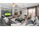 Open living room showcases a stone fireplace, ceiling fan, and glass sliding doors at 5123 W Redbird Rd, Phoenix, AZ 85083