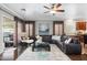 Living room features a ceiling fan, hardwood floors, and sliding glass doors to the patio at 5123 W Redbird Rd, Phoenix, AZ 85083
