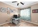 Cozy home office with decorative walls, a functional desk space, and window with curtains at 5123 W Redbird Rd, Phoenix, AZ 85083