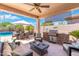 Inviting covered patio with built-in grill, comfortable seating, and a view of the pool at 5123 W Redbird Rd, Phoenix, AZ 85083