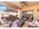 Inviting covered patio with outdoor seating, grill, stone accents, and convenient access to indoor living at 5123 W Redbird Rd, Phoenix, AZ 85083