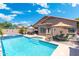 Inviting backyard oasis featuring a sparkling pool, lounge chairs, and a covered patio area perfect for outdoor entertaining at 5123 W Redbird Rd, Phoenix, AZ 85083