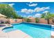 Stunning backyard featuring a sparkling pool with lush landscaping, perfect for outdoor relaxation and entertainment at 5123 W Redbird Rd, Phoenix, AZ 85083
