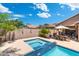 Backyard oasis featuring a sparkling pool, a spa, and a covered dining area, perfect for outdoor relaxation at 5123 W Redbird Rd, Phoenix, AZ 85083