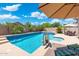 Beautiful swimming pool and spa with lush landscaping, a basketball hoop, and a patio with seating at 5123 W Redbird Rd, Phoenix, AZ 85083