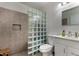 Bathroom featuring a glass block partition wall and tiled shower at 5216 E Half Moon Dr, Phoenix, AZ 85044
