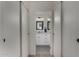 Hallway view of bathroom with white vanity and mirrors at 5216 E Half Moon Dr, Phoenix, AZ 85044