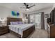 Cozy main bedroom featuring wood furniture, ceiling fan, and sliding glass door to yard at 5216 E Half Moon Dr, Phoenix, AZ 85044