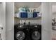 Closet view of side-by-side black Samsung washer and dryer at 5216 E Half Moon Dr, Phoenix, AZ 85044