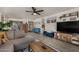 Spacious living room featuring a cozy sectional, a media center, and light wood floors at 5216 E Half Moon Dr, Phoenix, AZ 85044
