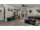 Bright living room featuring a TV, a blue bench, light floors, and sliding glass doors at 5216 E Half Moon Dr, Phoenix, AZ 85044