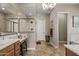 Bathroom with a chandelier above a vanity, a stand alone glass shower, and tile floors at 5258 S Verde --, Mesa, AZ 85212