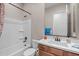 The bathroom features a shower and tub combination with a wooden vanity and blue towel at 5258 S Verde --, Mesa, AZ 85212