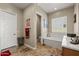 Spacious bathroom featuring tile floors, a soaking tub, and a water closet at 5258 S Verde --, Mesa, AZ 85212