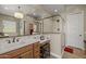 Bright bathroom with a chandelier above a large mirror, a stand alone glass shower, and a single vanity at 5258 S Verde --, Mesa, AZ 85212