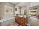 Bathroom featuring tile floors, a soaking tub, and a large window at 5258 S Verde --, Mesa, AZ 85212
