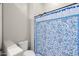 Bathroom featuring tile floors, white toilet, and a patterned blue shower curtain at 5258 S Verde --, Mesa, AZ 85212