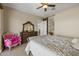 Bedroom featuring beige walls, decorative mirror and dresser, and decorative bright pink chair at 5258 S Verde --, Mesa, AZ 85212