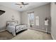 Bedroom with neutral walls, a queen-sized bed, window with light-filtering curtains, and a mannequin at 5258 S Verde --, Mesa, AZ 85212